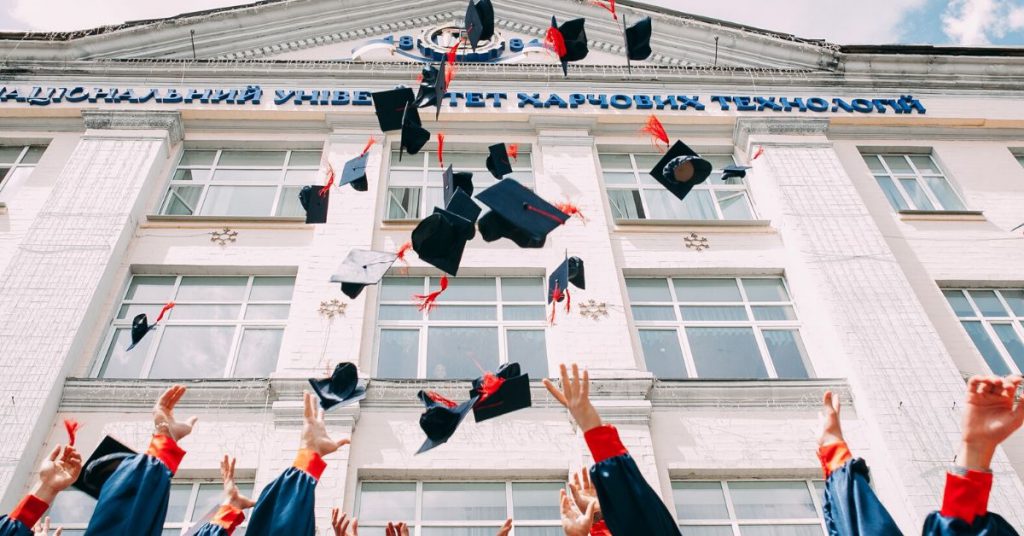 students throwing their graduation caps in the air