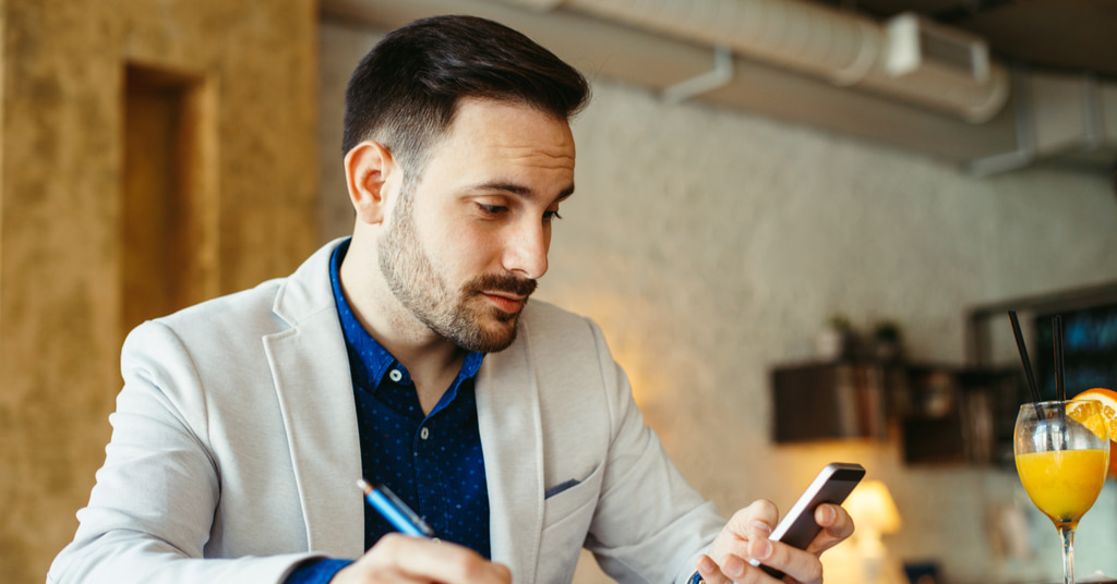 a cfa candidate preparing for the exam with his mobile