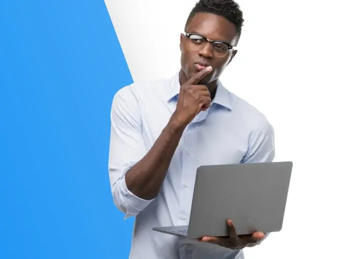 Man looking puzzled by question on his laptop