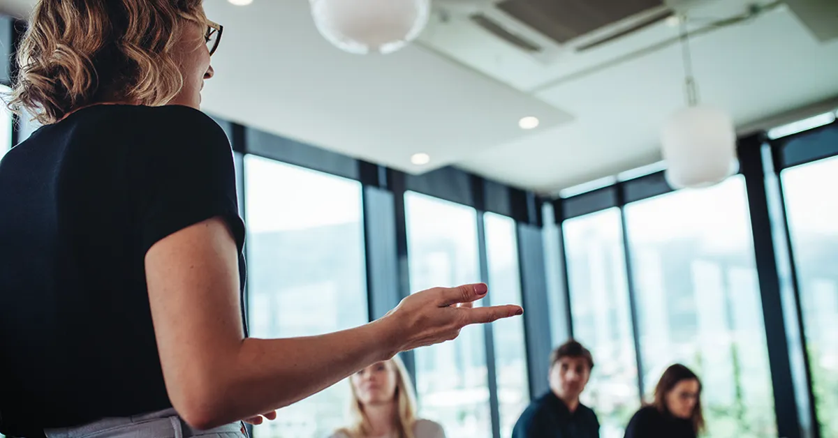 Female analyst making a presentation to her colleagues in the office conference room