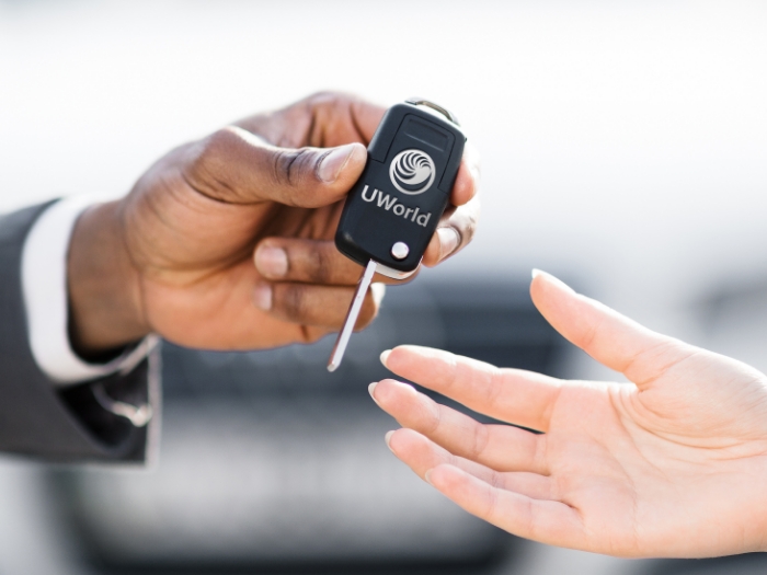 Man is handing keys over to a new car representing the “UWorld CFA test Drive”.